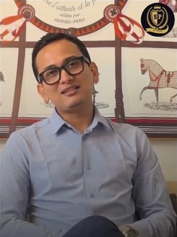 Snehaashish Pathakk in a light-blue shirt and black-framed glasses, seated, speaking in an interview, January 2026.